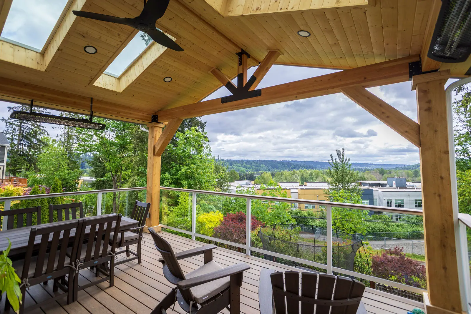 Covered patio with cedar ceiling, skylights and glass railing